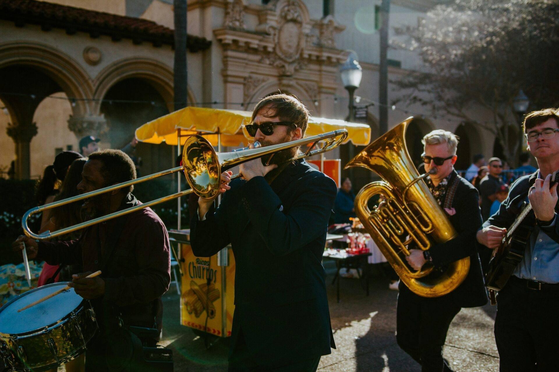 Musiciens jouant de la trompette et du tuba dans une cour historique lors d’une célébration festive