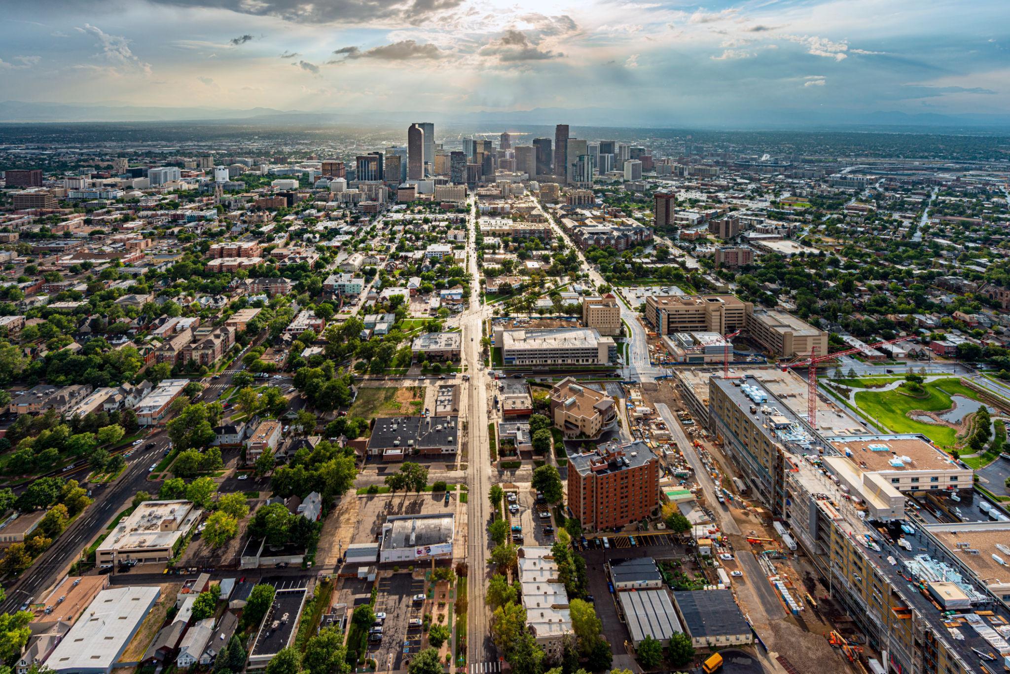 Vue aérienne d’une grande ville américaine avec gratte-ciel au centre et quartiers résidentiels étendus sous ciel nuageux