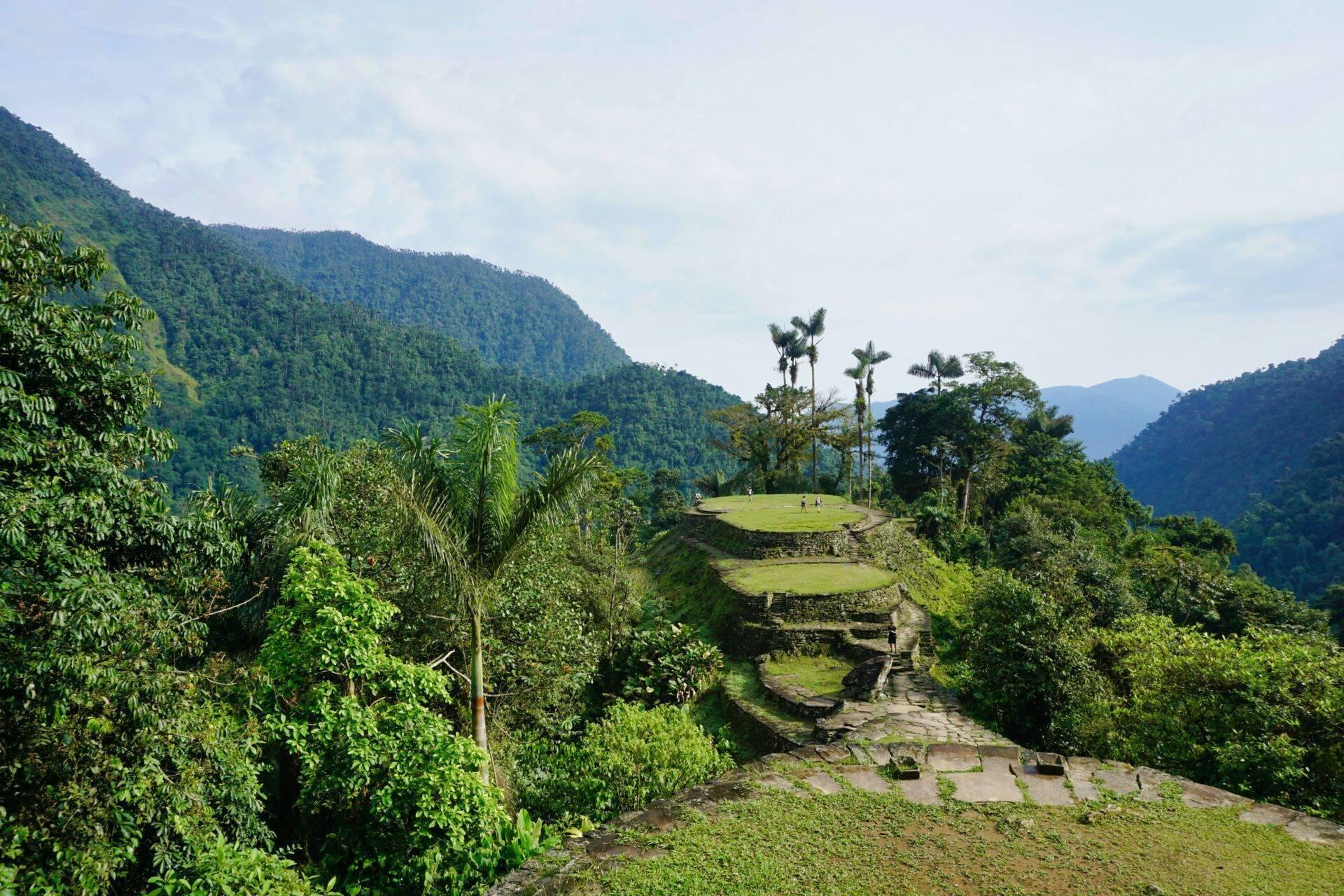 Ruines archéologiques escarpées entourées de végétation luxuriante dans une vallée montagneuse tropicale