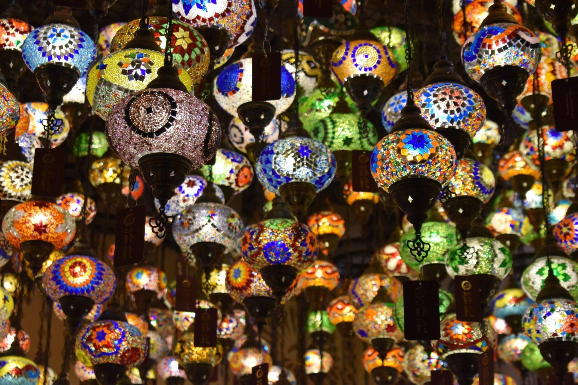 Collection de lanternes marocaines colorées suspendues avec motifs géométriques et verres teintés bleus, orange et verts